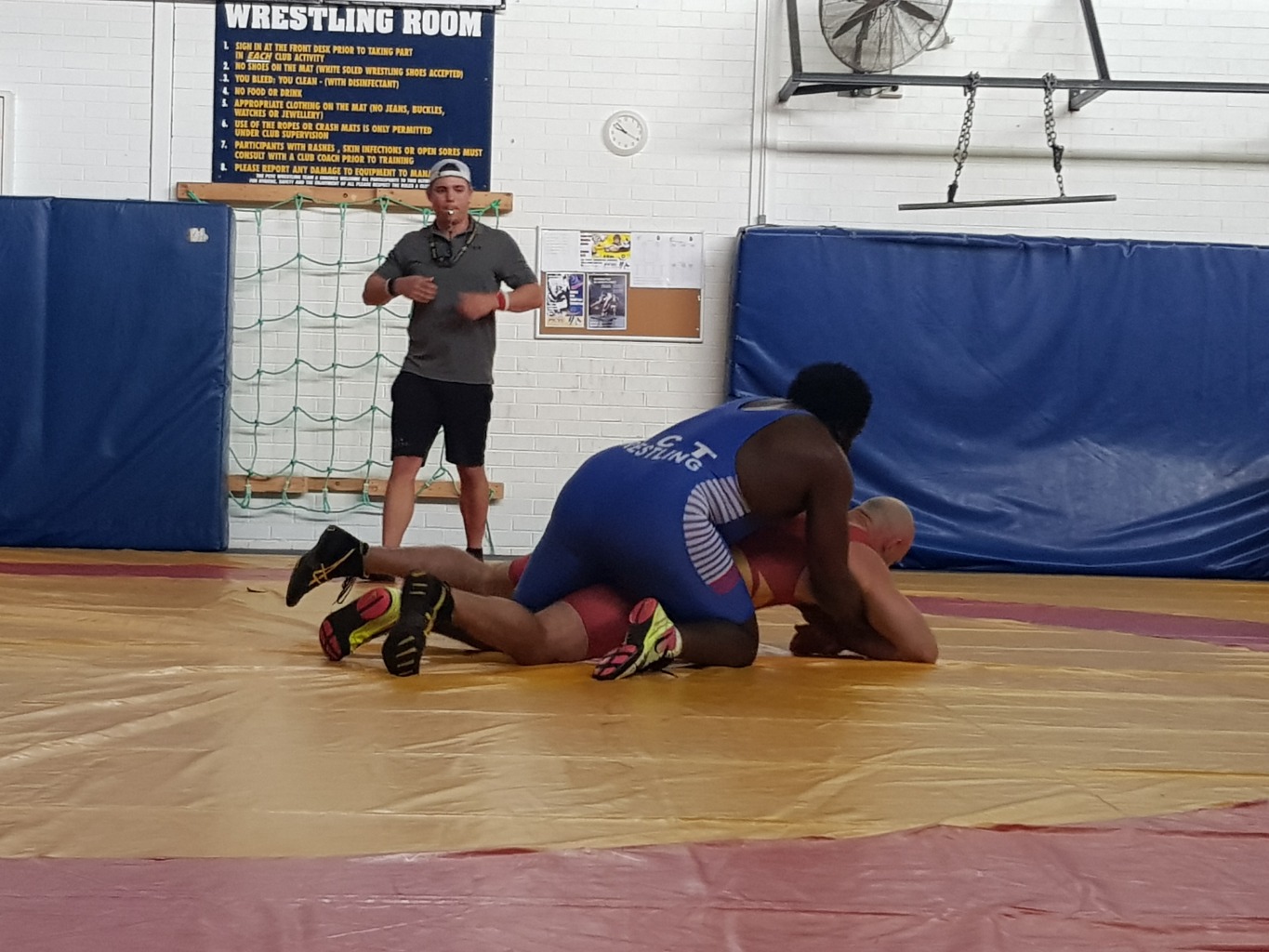 Wrestlers training on the mat in the wrestling room at PCYC Erindale